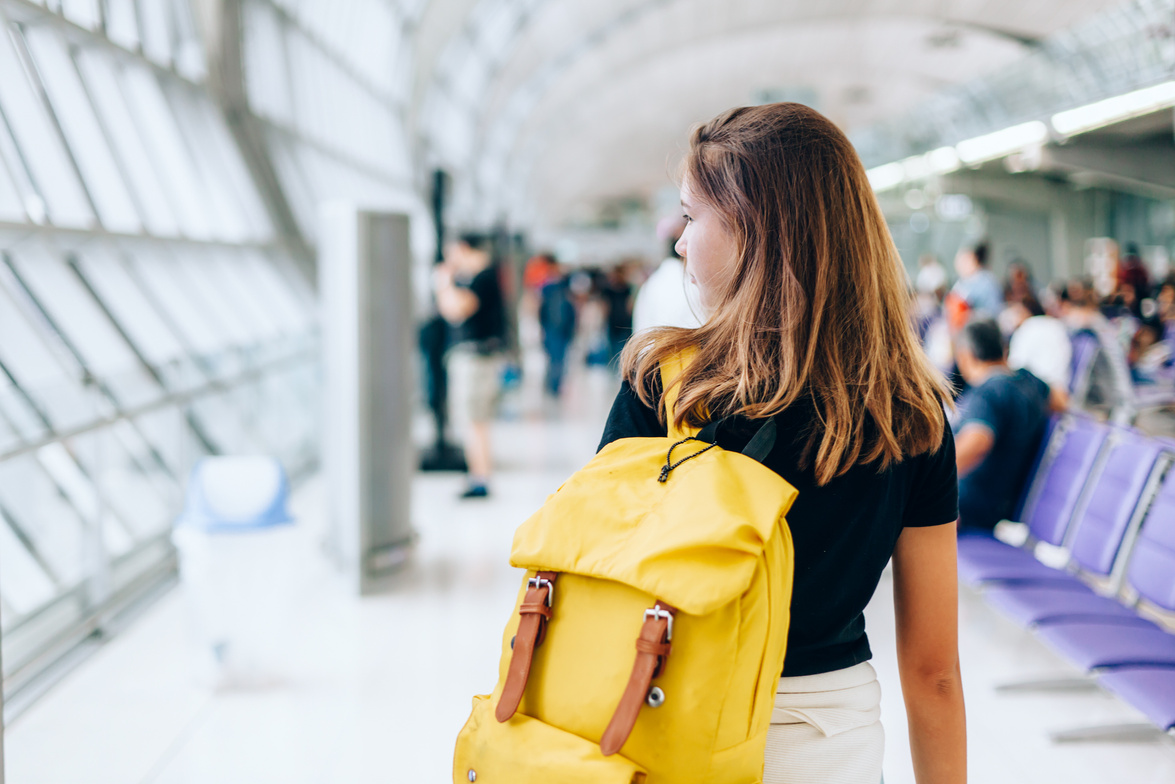 Teen Girl Waiting Flight in Airport Departure Area